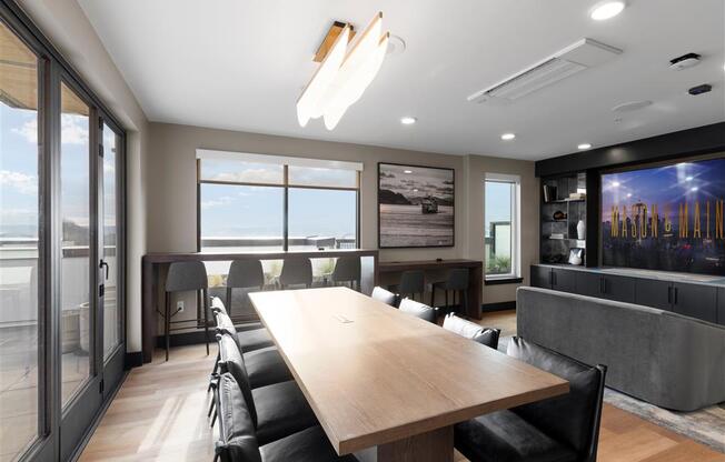 a conference room with a large wooden table and black leather chairs