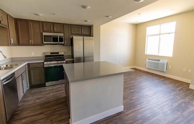 kitchen and living room with a large window at Loma Villas Apartments in San Bernardino, CA