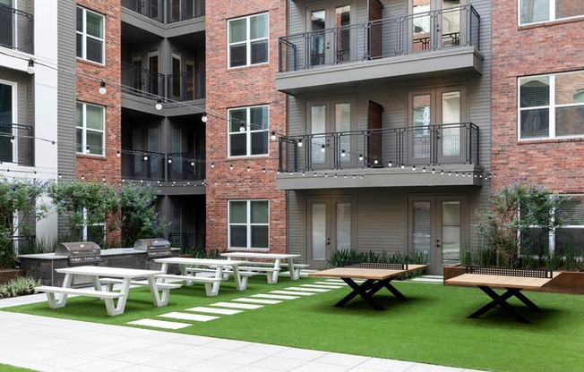 Dine Al Fresco in the Recreation Courtyard with Cornhole + BBQ Grill