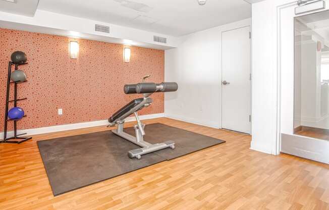 gym area with a weight machine and mirror