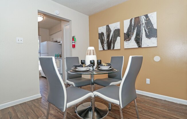 A dining room with a table set for four at The Drake in Bossier City, LA