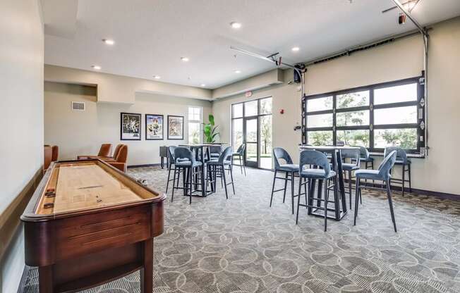game room with a pool table and tables