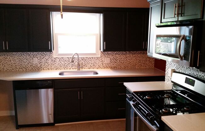 Modern 2 Bed/1 Bath row house with off-street parking!