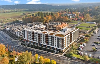 A large building with a parking lot in front of it.