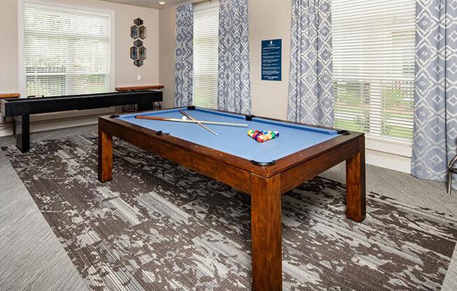 a pool table in a living room with windows at Promenade at Newnan Crossing, Georgia, 30265