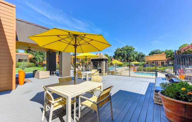 Pool Lounge  Area with Yellow Umbrellas, Grills, Gates with View of Pool