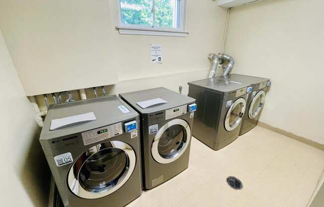 a washer and dryer in a laundry room with a window at Eagle Pointe New London, CT, 06320