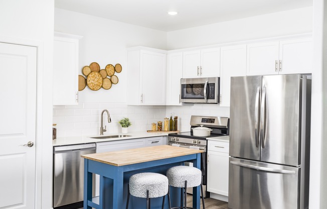 Cook in style at Aster Ridge! Our gourmet kitchens feature sleek quartz countertops, elegant white shaker cabinetry, and a designer tile backsplash.