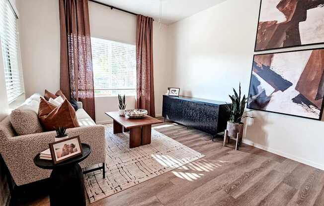 A living room with a brown sofa, a coffee table, and a painting on the wall.