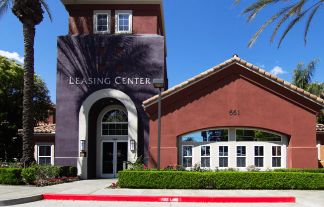 A building with a leasing center sign on it.