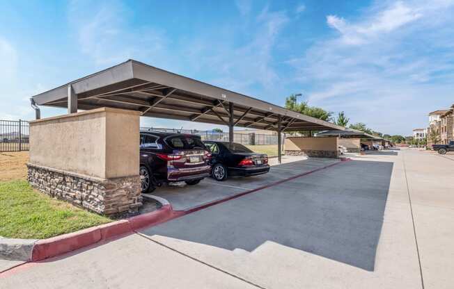 a parking garage with cars parked under it