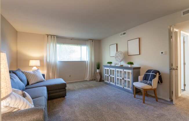 This is a photo of the living room in the 822 square foot, 2 bedroom, 1 bath floor plan at Village East Apartments in Franklin, OH.