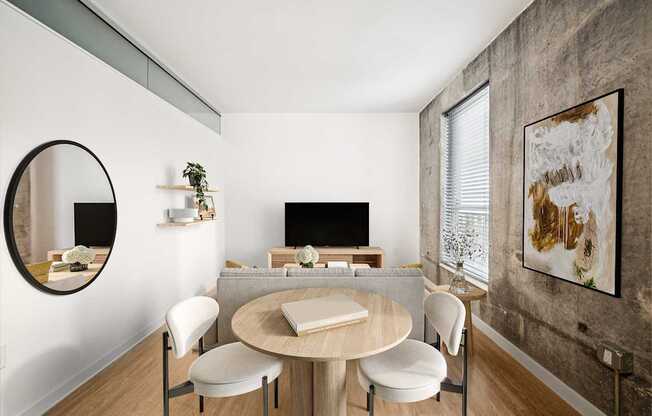 A modern dining room with a round table and chairs.