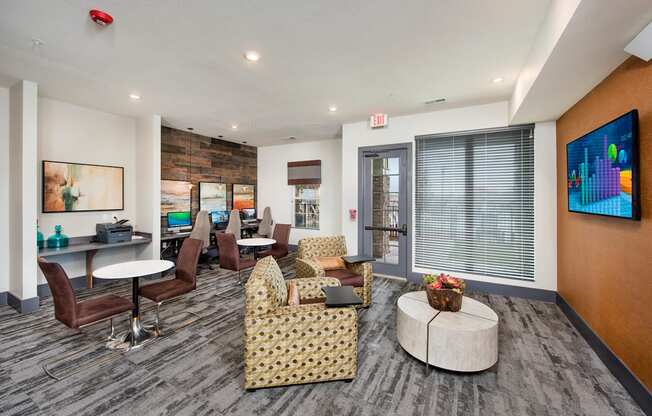 a living room with couches and chairs and a tv