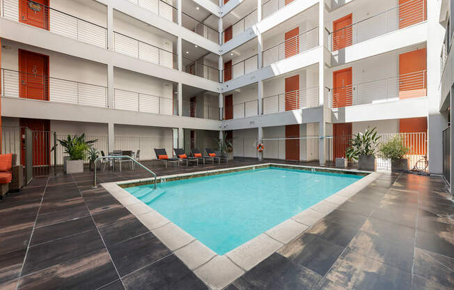 A large indoor swimming pool in a multi-story residential building.