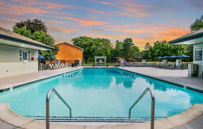 A large swimming pool with a metal ladder in the foreground.