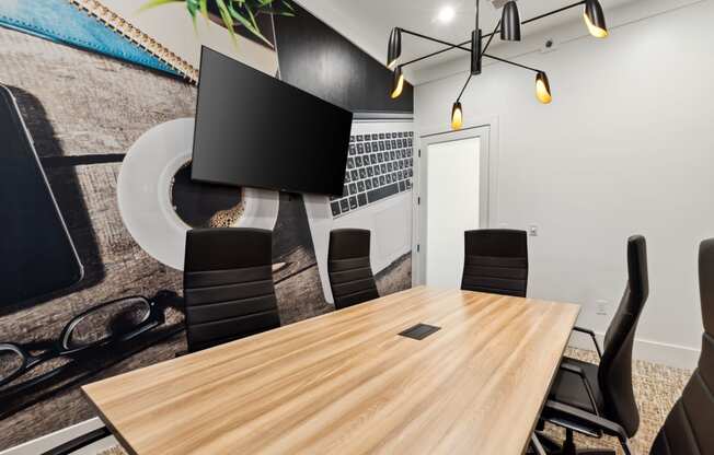 a conference room with a wooden table and black chairs