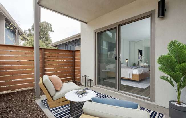 a bedroom has a patio with a couch and a coffee table