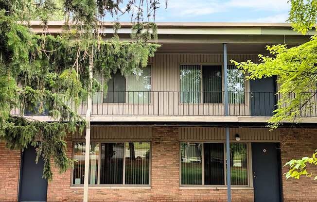 A building with a balcony and a black door.