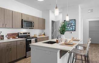 A modern kitchen with a dining table set for two.