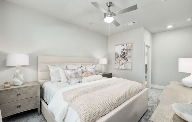 A bedroom with a large bed and a ceiling fan at The Ashton at East Park Apartments, Kennesaw