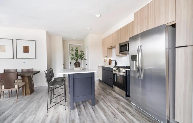 Sleek kitchens at Modera Westside Trail feature a spacious island and multiple contemporary finish options, creating a refined space for everyday living.