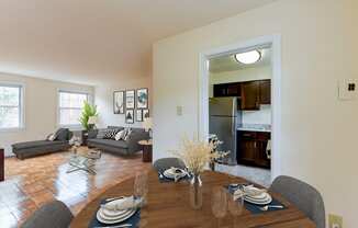 dining area with table, chairs, view of kitchen and living area at colonnade apartments in washington dc