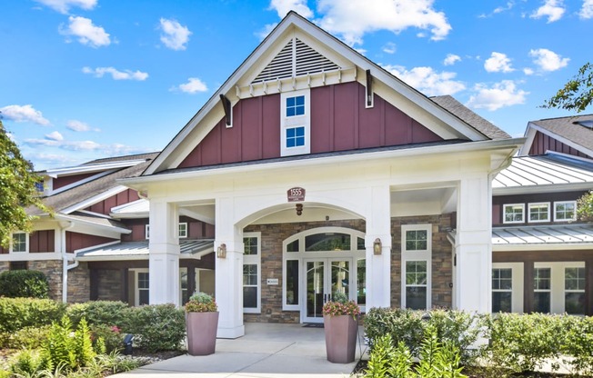 the exterior of a building with a porch and a pathway
