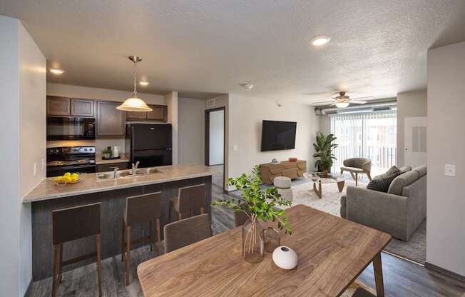 A modern kitchen with a bar and a dining table.