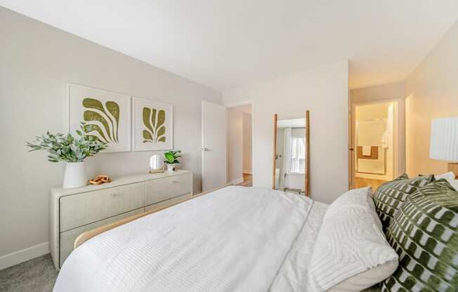 a bedroom with a large bed and a dresser with a plant on it  at Citrine Hills, California, 91761