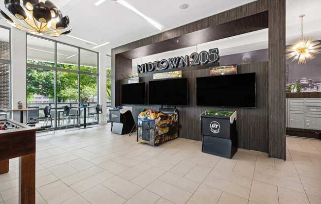 a view of the lobby at midtown 206 with a variety of games on the wall and