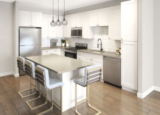 Beautiful kitchen with white cabinetry,  quartz countertop, and stainless steel appliances