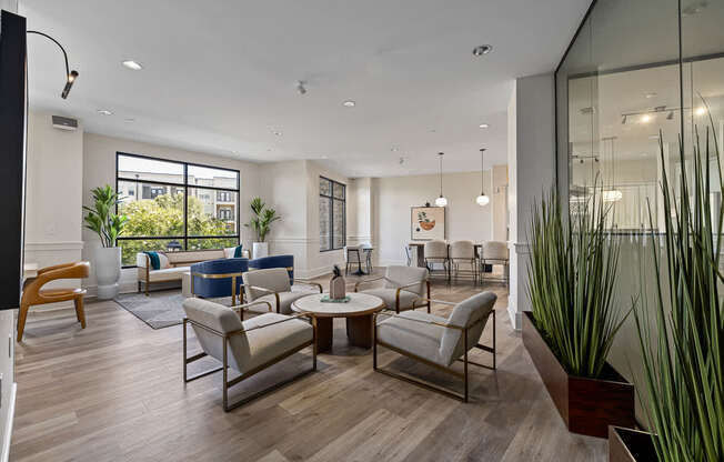 A modern living room with a glass wall and a wooden floor.