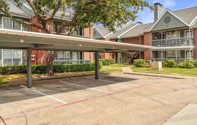 a carport in front of a brick building