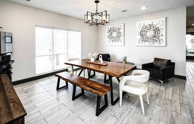 a dining room with a wooden table and chairs