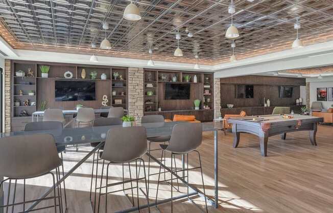 A modern dining area with grey chairs and a wooden table.