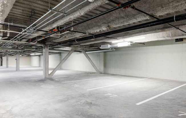 A large, empty parking garage with concrete floors and walls.