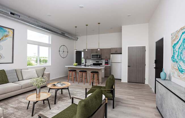 A living room with a couch, chairs, and a dining table.