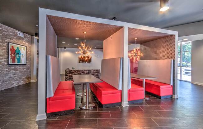 A room with a table and chairs with a red cushion at Highland Row Apartments, Memphis