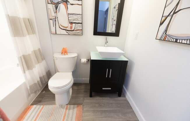 a bathroom with a toilet and a sink and a mirror