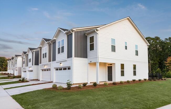 Modern townhome exteriors at Amavi Brier Creek, offering refined living in Durham with convenient access to Brier Creek’s shopping, dining, and commuter routes.