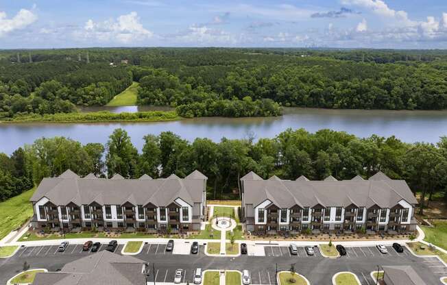 an aerial view of an apartment complex with a lake in the background