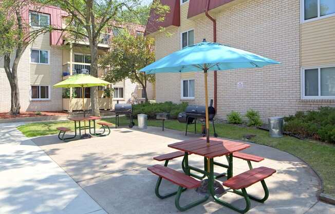 Outdoor picnic tables with colorful umbrellas