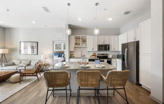 a living room with a kitchen and a dining table