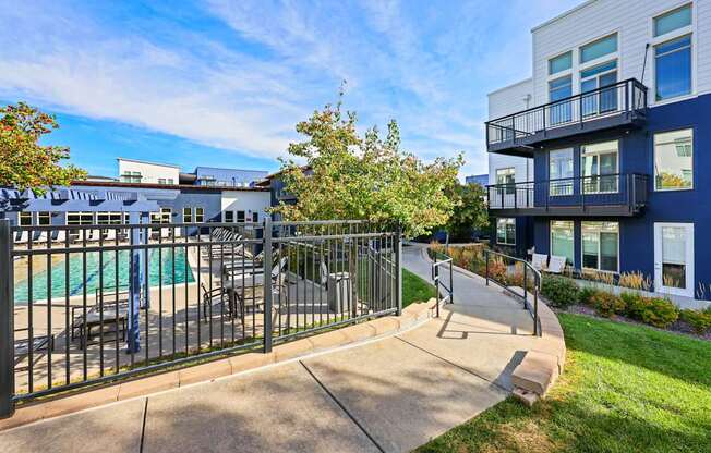 A black metal fence surrounds a pool area.