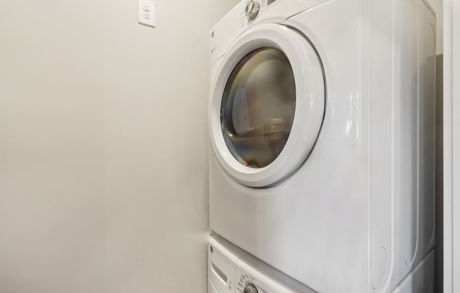 A white washing machine in a laundry room.