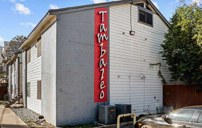 a white building with a red sign on the side of it