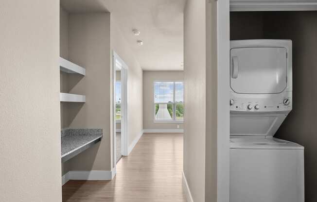 an empty laundry room with a washer and dryer in it