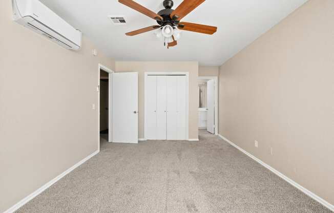 an empty living room with a ceiling fan and carpet at Diamond Ridge Townhomes, Oklahoma City, OK