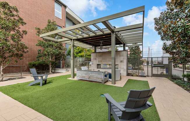 A patio with a table and chairs under a roof.